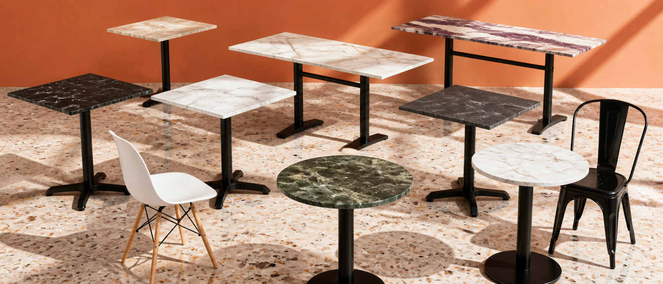Colección de mesas de piedra sinterizada para restaurante Casa Ferro: Calacatta, Negro Marquina, Verde Tropicus, Pietra Gray y Calacatta Viola sobre bases de fierro fundido cruz, disco y doble pedestal